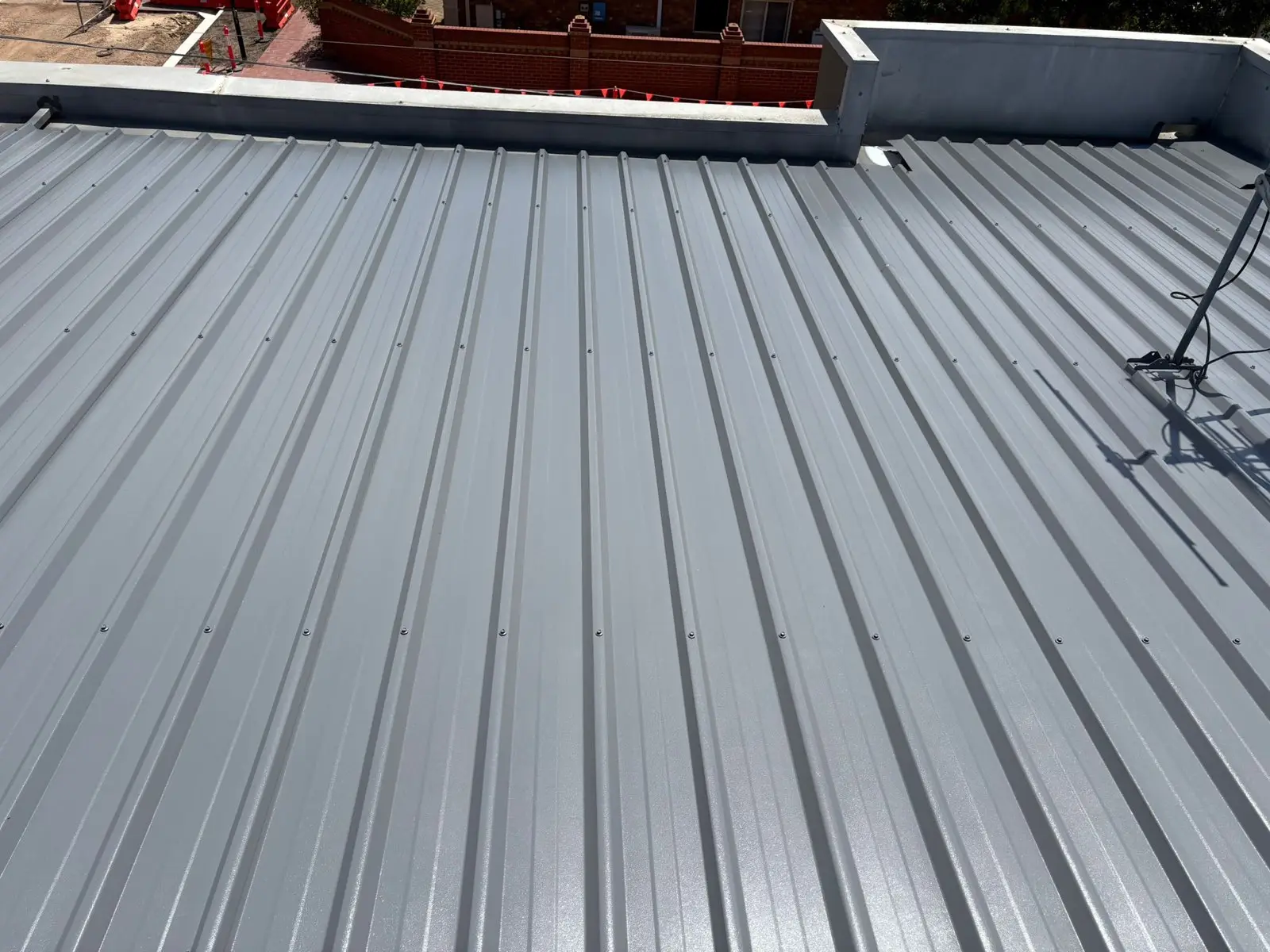 New grey Trimdek metal roof against a parapet wall