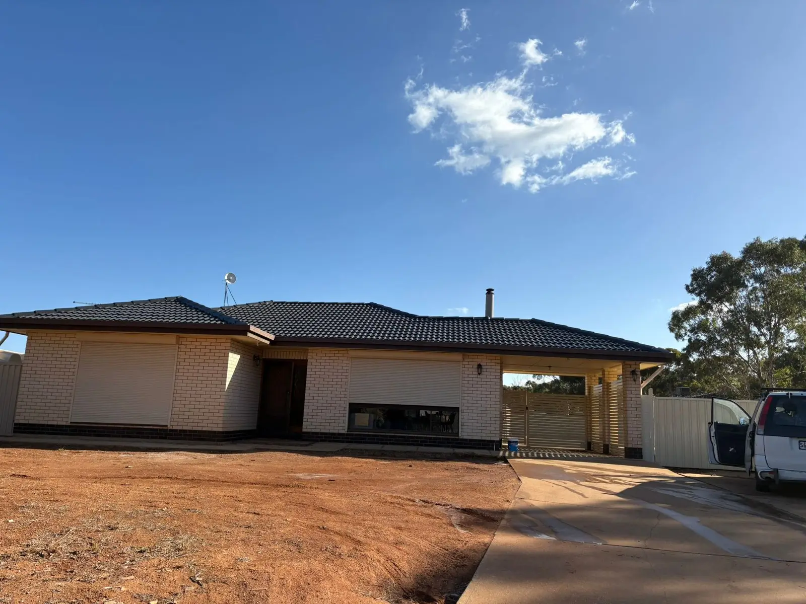 Country home with restored dark tile roof