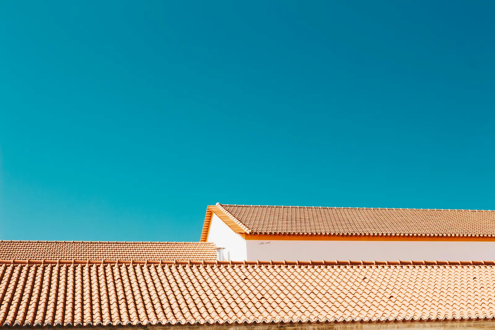 Terracotta tiled rooftops against a clear sky